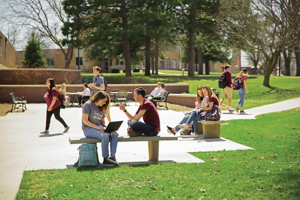 Students sitting outside on benches